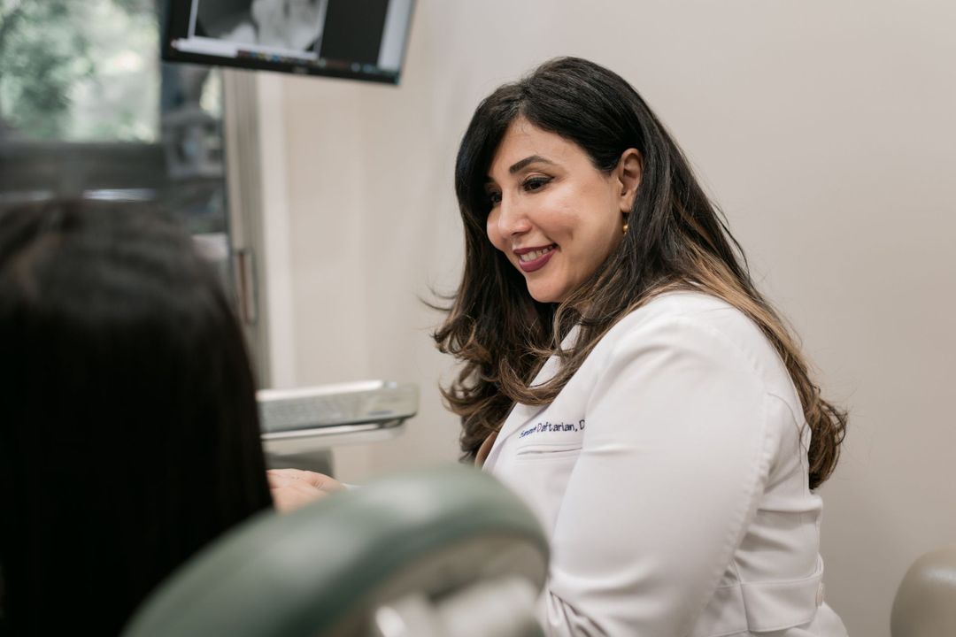 Dr. Daftarian talking to a female patient