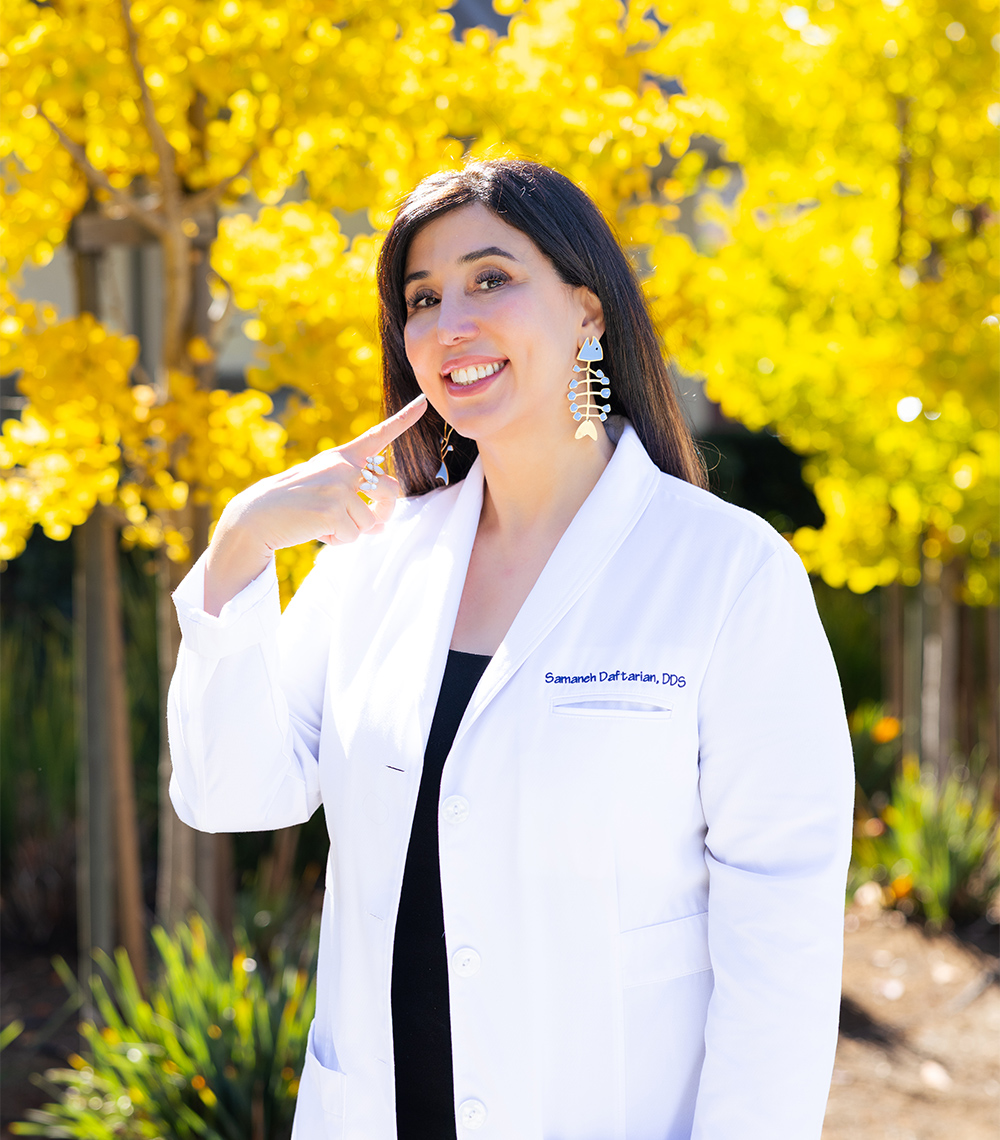 Dr. Samaneh Daftarian, a Cosmetic Dentist Serving the Palo Alto Community Smiling Dr. Samaneh Daftarian in a white coat highlighting cosmetic dental care in the Palo Alto community